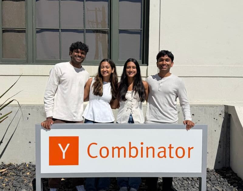 The four Kairos Health founders together behind the Y Combinator sign